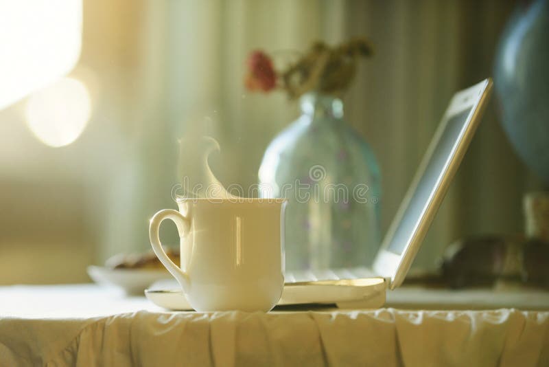 Cup with hot tea near computer. Coffee time stock photography Cup with hot tea near computer. Coffee time stock photography