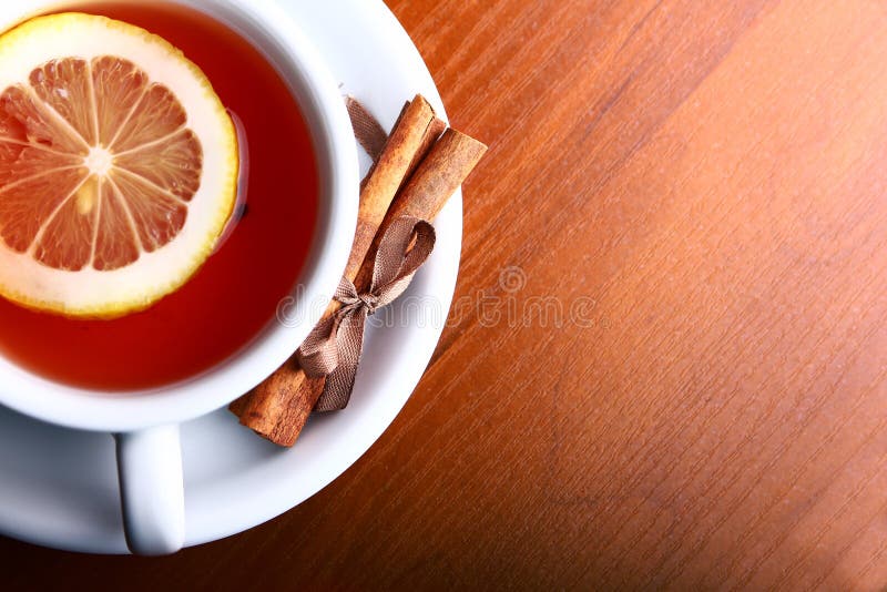 Cup of hot tea on wooden background