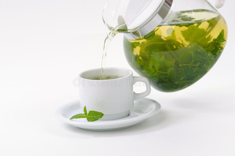 Cup with mint tea and teapot