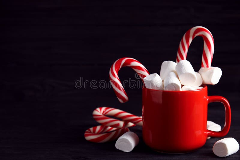 https://thumbs.dreamstime.com/b/cup-tasty-cocoa-marshmallows-christmas-candy-canes-black-wooden-table-space-text-cup-tasty-cocoa-201032387.jpg