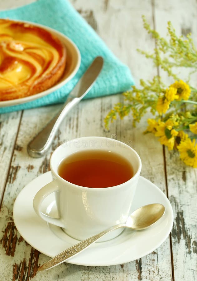 Cup of Tea, Cake and Yellow Flowers on Old Wooden Stock Image Image