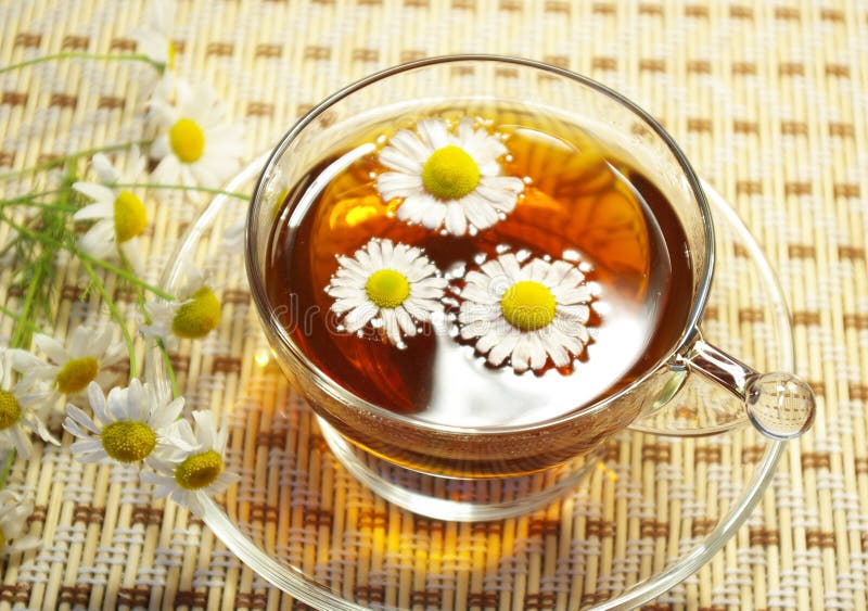 Cup of tea and chamomile blossoms