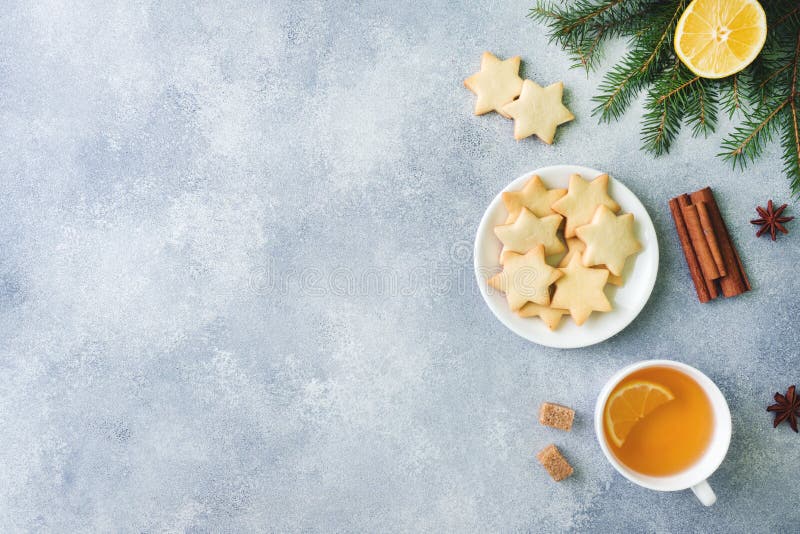 Cup of tea and cookies, pine branches, cinnamon sticks, anise stars. Christmas, winter concept. Flat lay top view