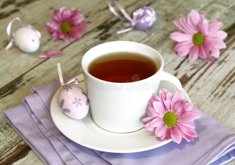 cup of tea, easter eggs and chrysanthemums on old