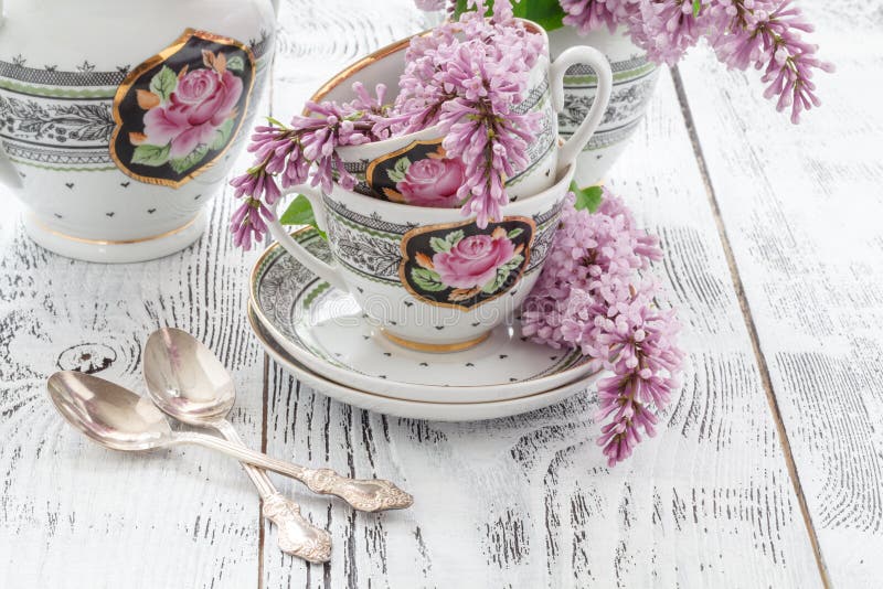 Cup of tea with lilac spring flowers on the wood table. White ba royalty free stock image Cup of tea with lilac spring flowers on the wood table. White ba royalty free stock image