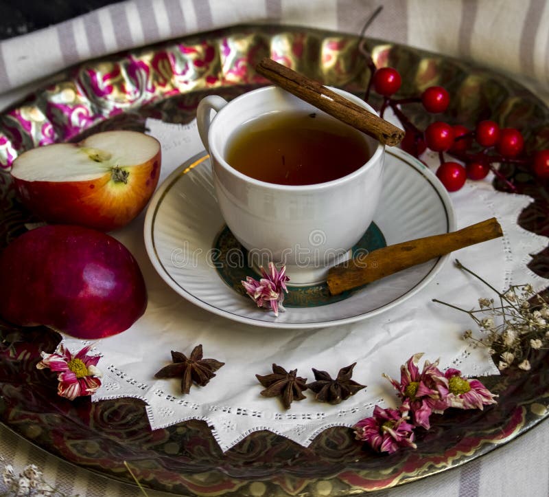 A Cup of Tea with Red Apples and Cinnamon Stock Photo Image of orange