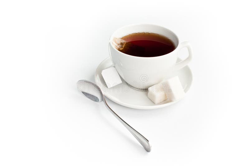 Cup of tea with sugar and teabag isolated on white