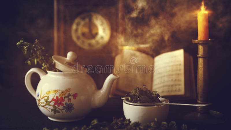 Cup of Tea and Teapot on wooden table with vintage clock, burning candle and old book