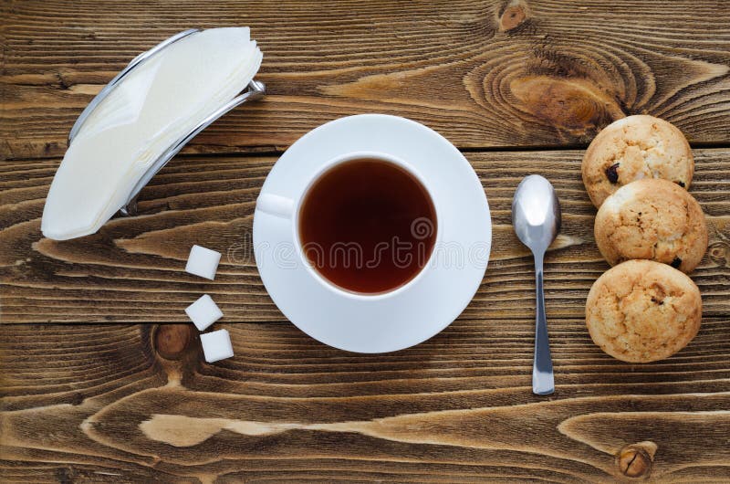 Cup of tea on a wooden table, top view