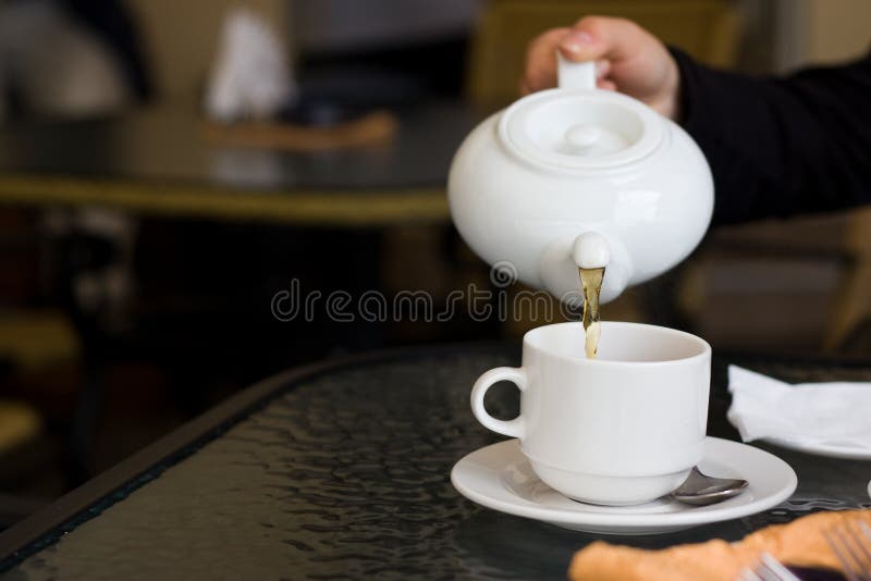 Cup and teapot in cafe