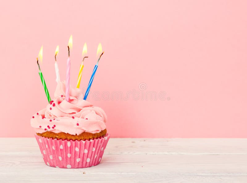 Cupcakes with cream and with five candles