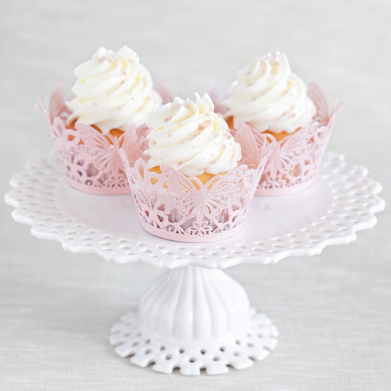 Cupcakes with vanilla cream on cake stand