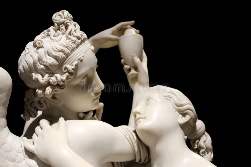 Cupid and Psyche white marble statue isolated on black background