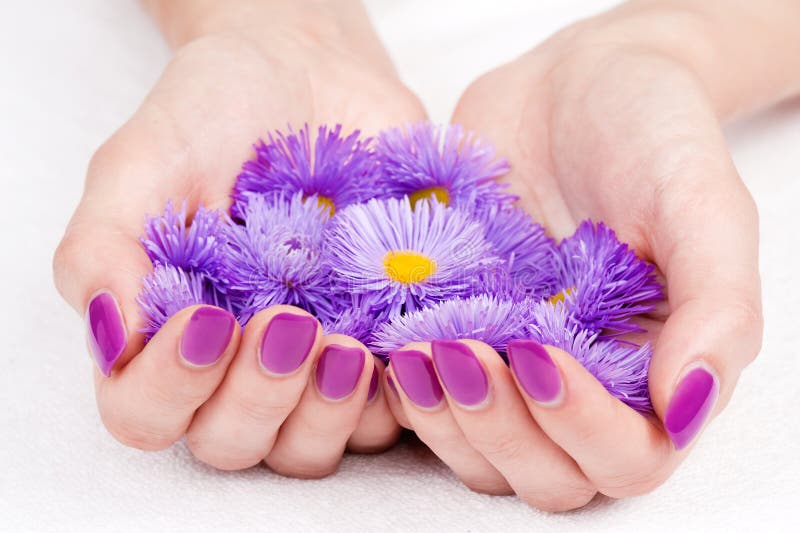 Cupped hands with manicure and flowers