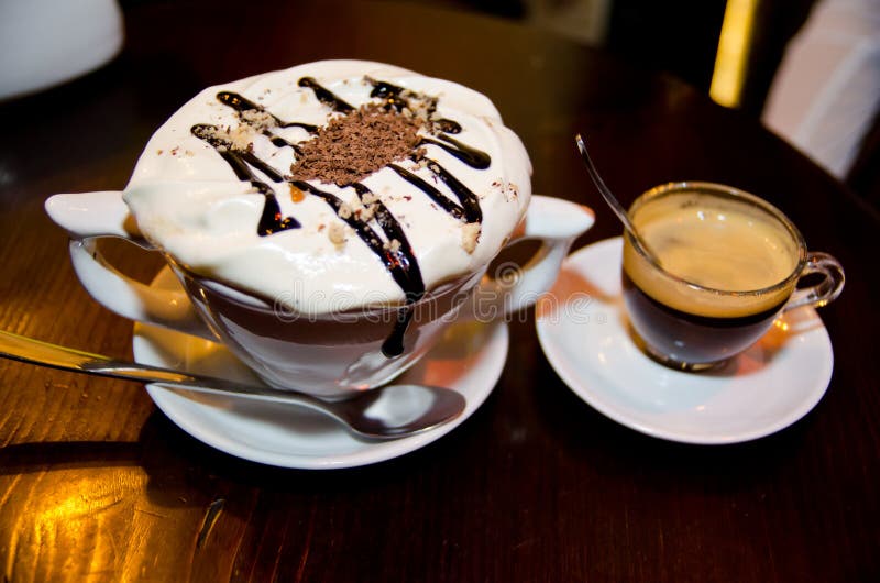 Two Cups of Coffee and Candy in the Form of Heart on a White Background