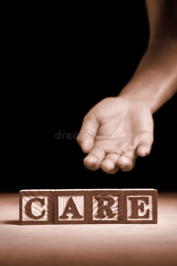 Word 'Care' from wooden block with hand gesture on background. Word 'Care' from wooden block with hand gesture on background