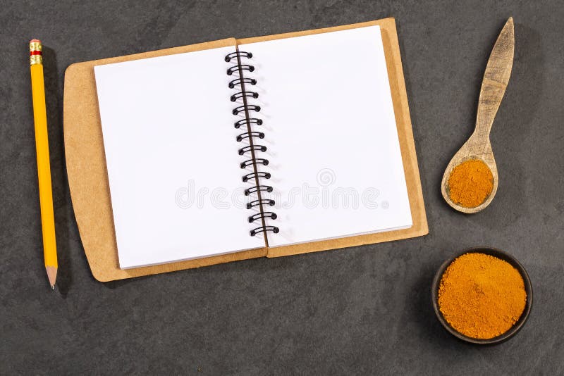 Curcuma longa - Organic turmeric powder with notebook stock images