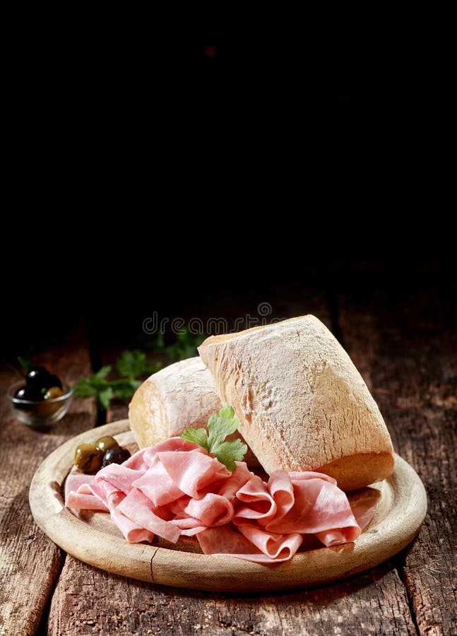 Cured ham with crusty rolls for a country lunch