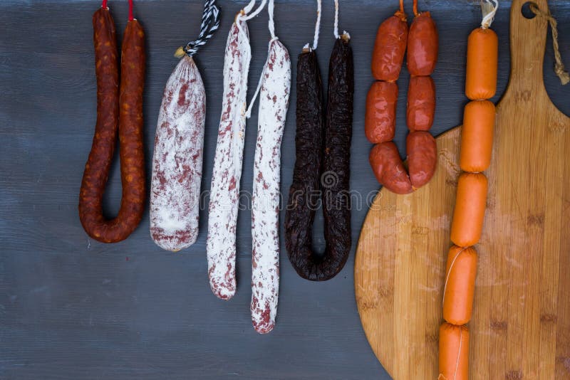 Cured meat and sausages stock image. Image of dark, board 81016601