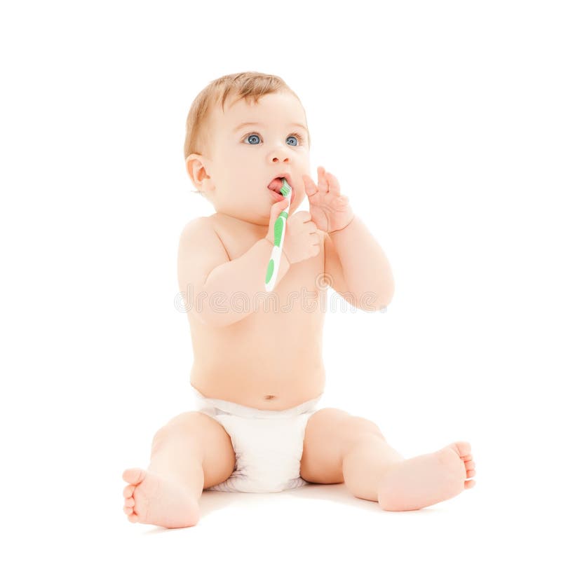 Curious baby brushing teeth stock images