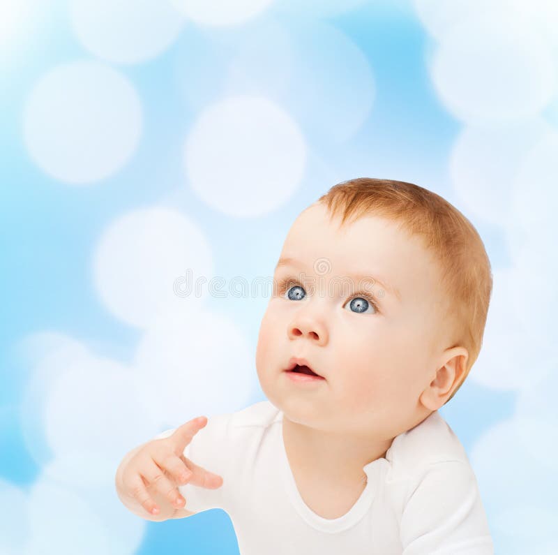 Curious baby looking up stock photo