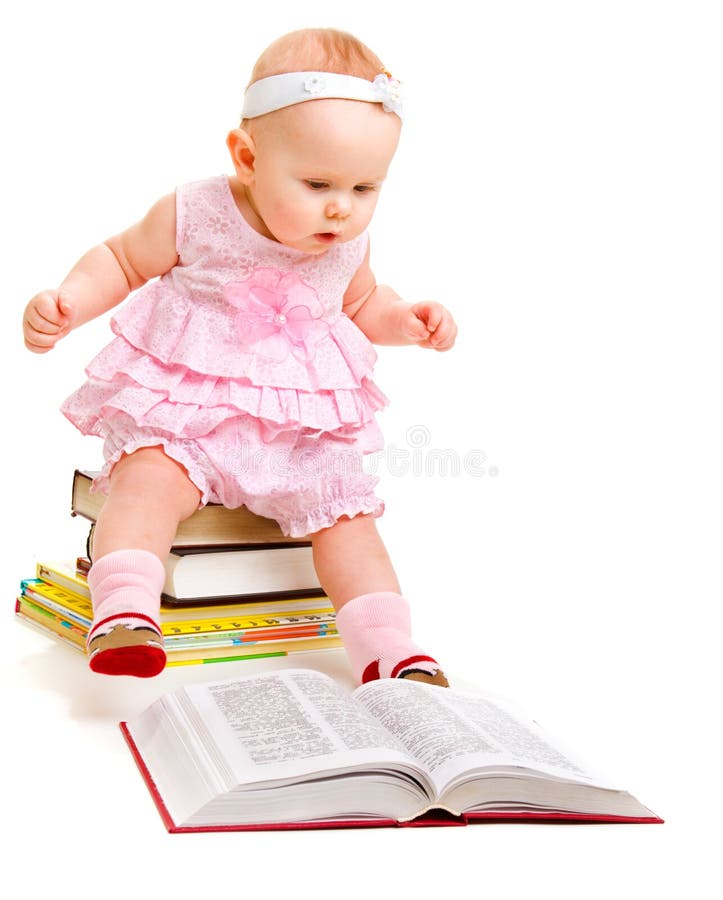 Curious baby reading a book stock photo