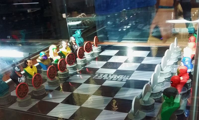 Two men admiring a Marvel characters` chess board royalty free stock photography Two men admiring a Marvel characters` chess board royalty free stock photography