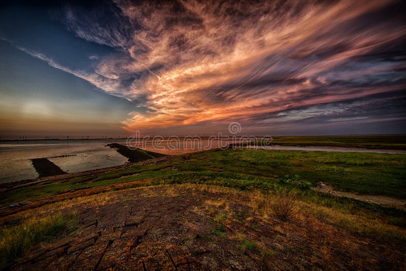 Curious cloud formation at sunset over the Dollard, a bay of the wadden sea in the north of the Netherlands. Curious cloud formation at sunset over the Dollard, a bay of the wadden sea in the north of the Netherlands.