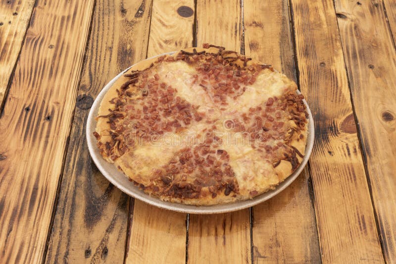 A Curious Deepdish Pizza with Cheese and Lots of Fried Bacon and Onion