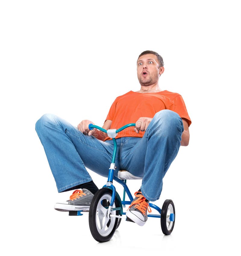 Curious funny man in orange t-shirt and jeans on blue children`s bicycle, isolated on white background