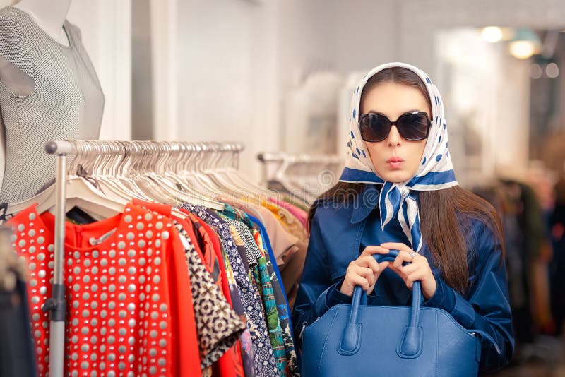 Surprised retro young woman in a raincoat in a clothing store. Surprised retro young woman in a raincoat in a clothing store