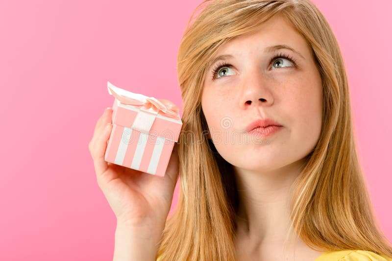 Curious girl holding unopened present