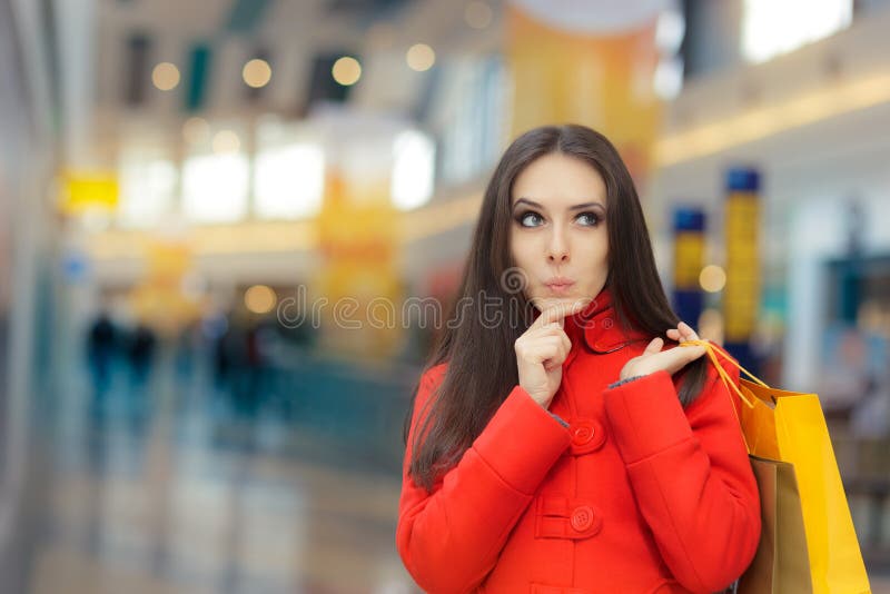 Curious Girl in a Red Coat Shopping in a Mall royalty free stock image Curious Girl in a Red Coat Shopping in a Mall royalty free stock image