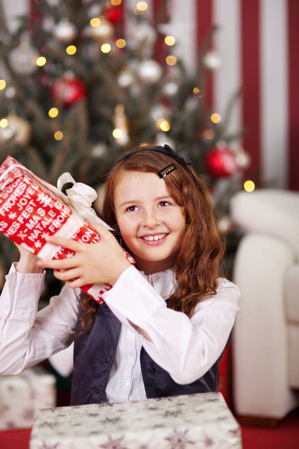 Girl is Shaking Happy Christmas Present Stock Photo - Image of present ...