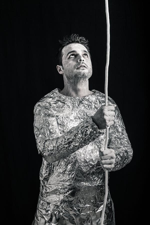 Curious spaceman with rope royalty free stock image