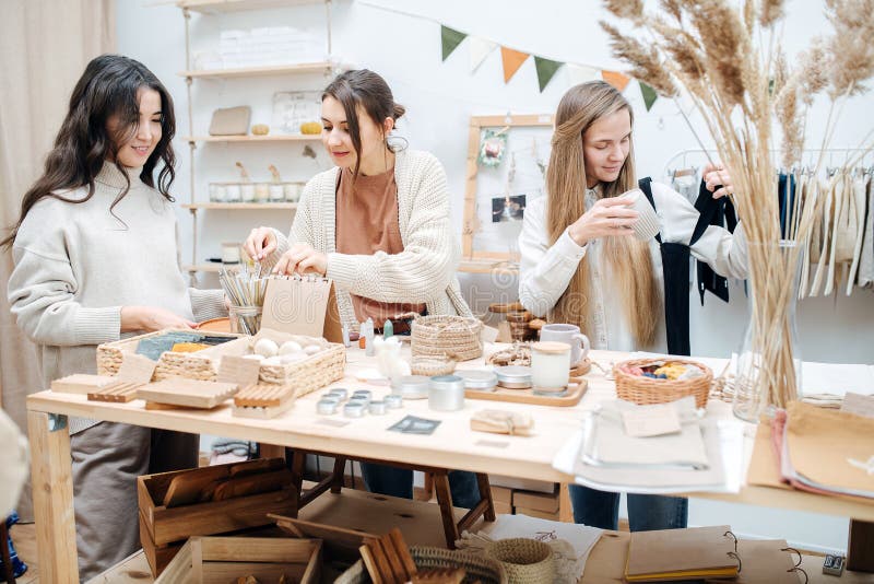 Curious young women in ecological shop choose between various cosmetic products