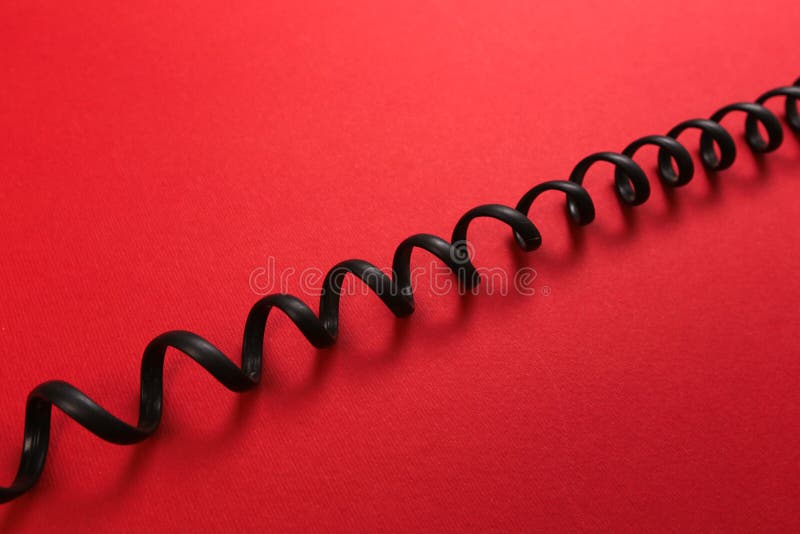 Curl black wire on red background stock photo