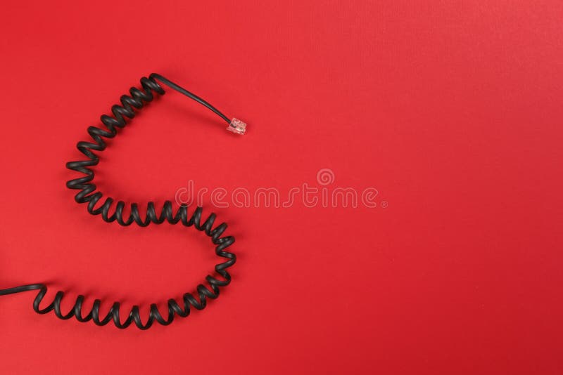 Curl black wire on red background royalty free stock photo