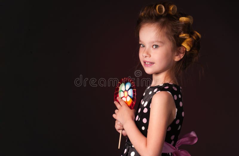 Curly girl with lollipop