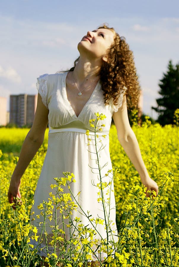 Curly girl on nature looking sky