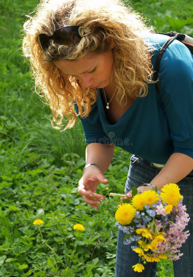 Curly girl picking flowers