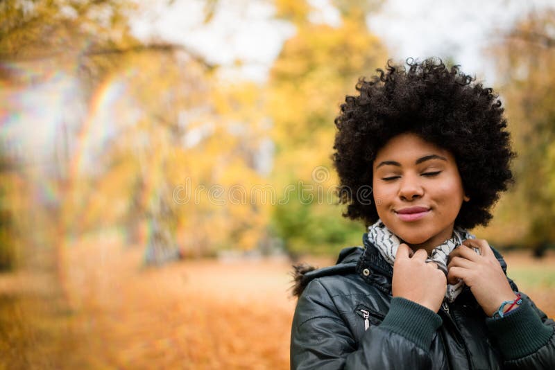 Curly hair woman with closed eyes in the park royalty free stock photos Curly hair woman with closed eyes in the park royalty free stock photos