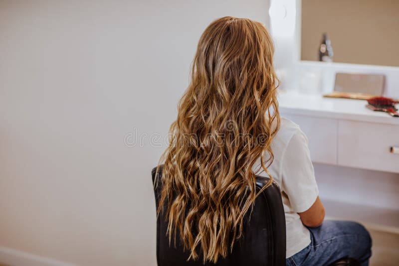 Teen Girl with Long Curly Hair and Make Up Posing Near the Wall with Copy  Space Stock Photo - Image of portrait, model: 214636476