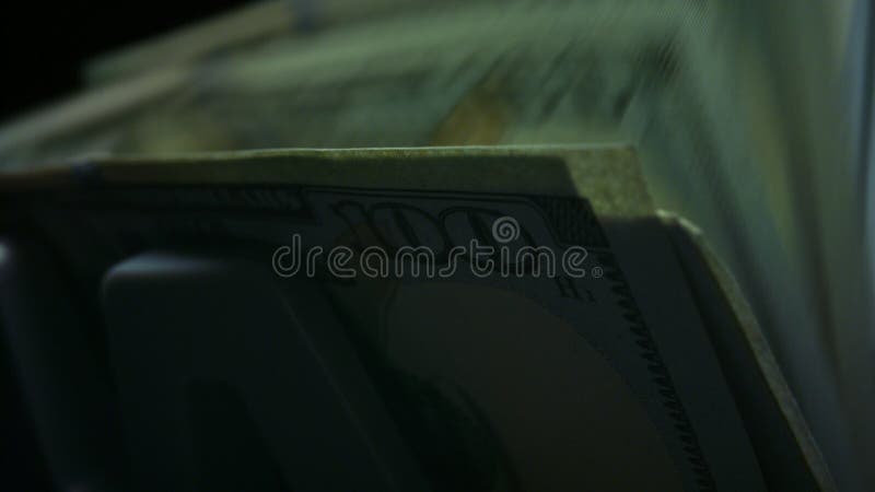 Currency counting equipment. Electronic banknote counter counting dollar bills stock photo