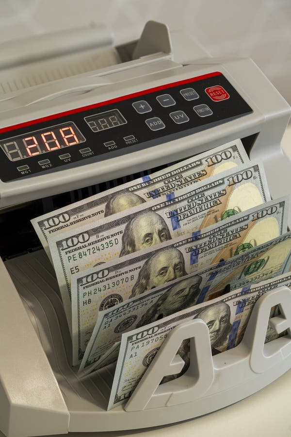 Currency counting machine in action at a financial institution royalty free stock image