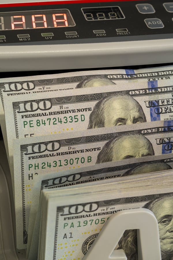 Currency counting machine displays fresh one hundred dollar bills royalty free stock image