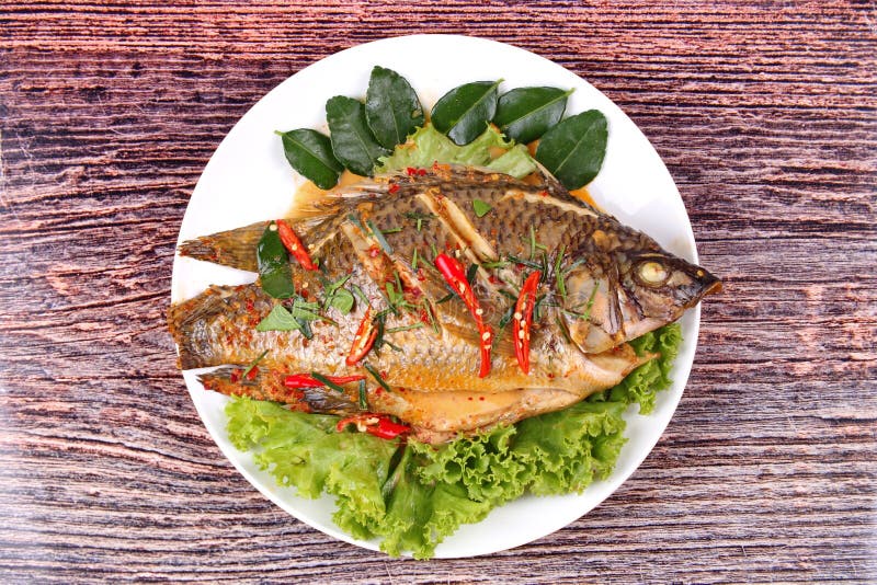 Curryfried Tilapia Fish with Spicy Topping. Stock Image Image of