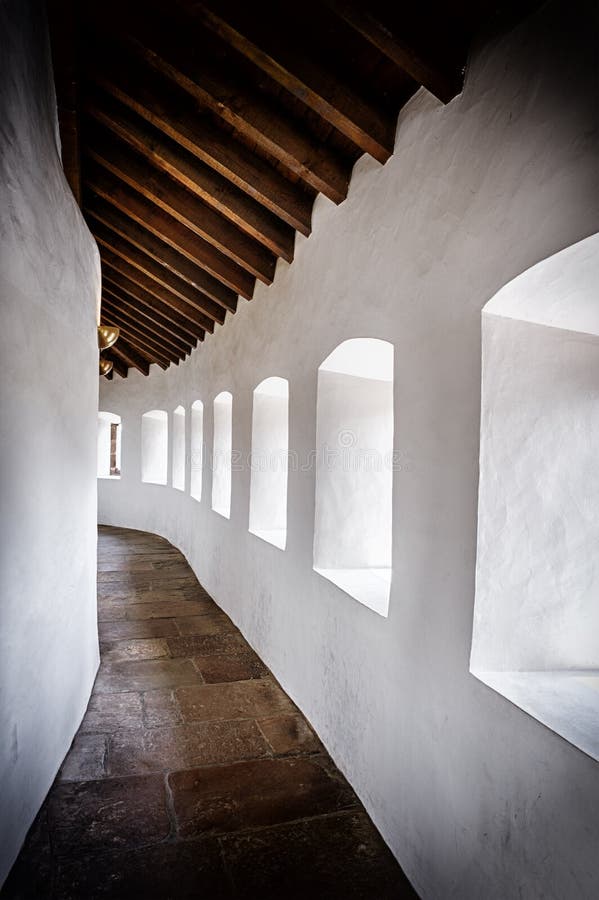 Curved passage in ancient castle royalty free stock photo