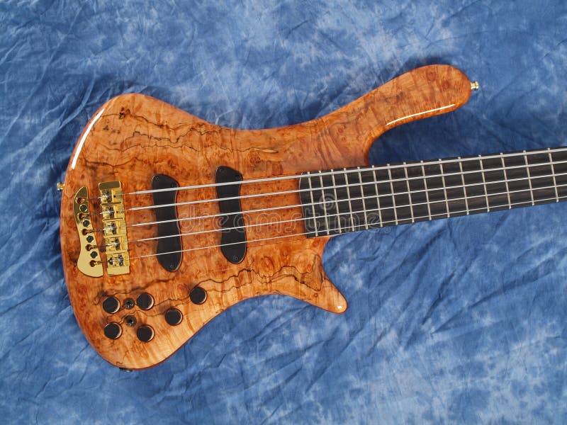 Curved patterned wood bass guitar body