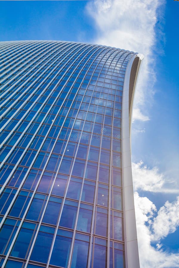 Curved Skyscraper Against Blue Sky Stock Photo - Image of blue, lower : The amazing picture depicting an stunning view. Its colors are just striking and mix perfectly. Its composition is wonderful, and the features are highly clear.